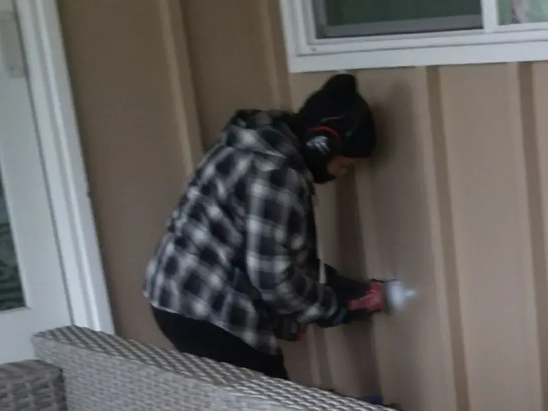 Professional electrician installing an exterior outlet in Randolph